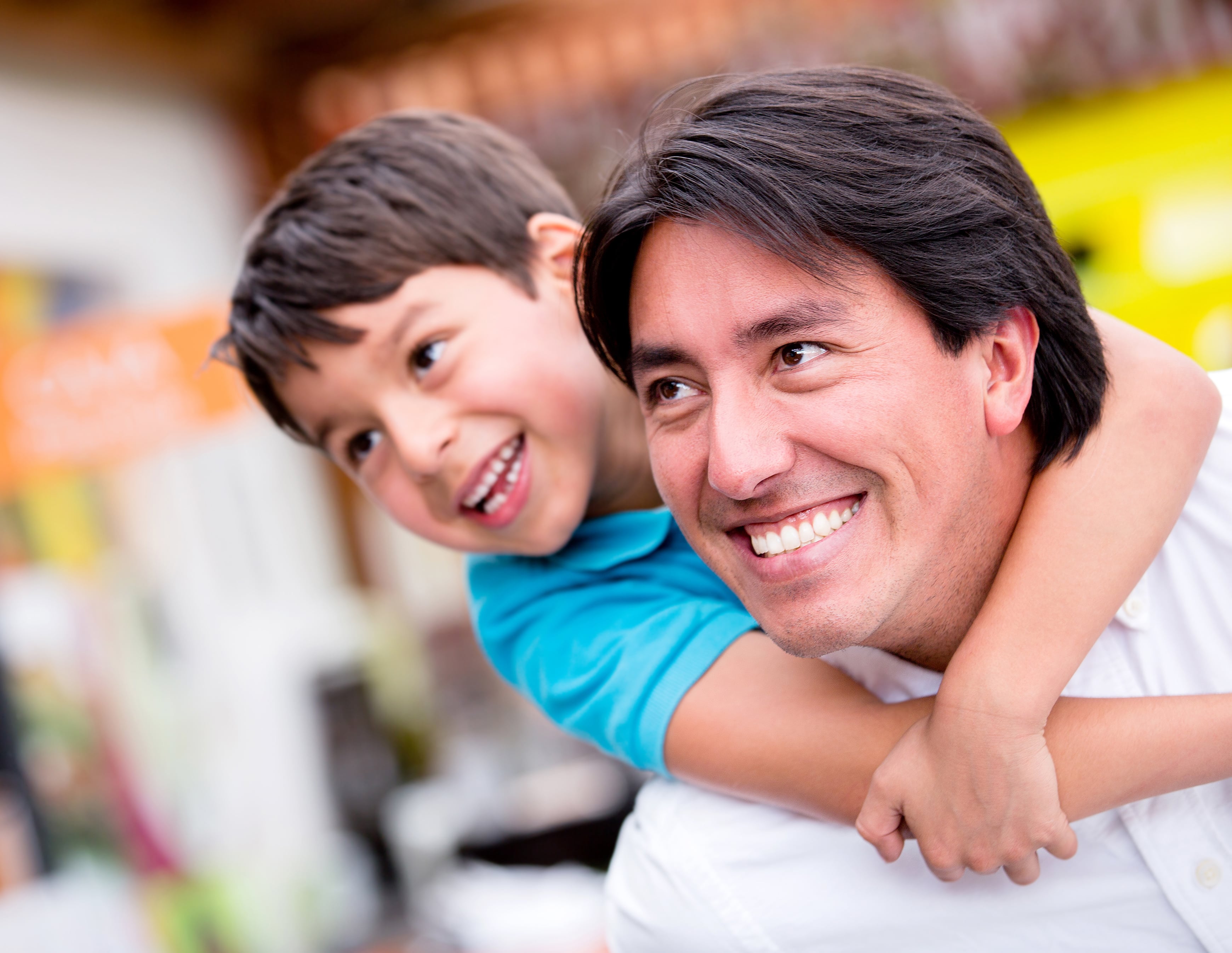 Man With Child Hanging On Shoulders